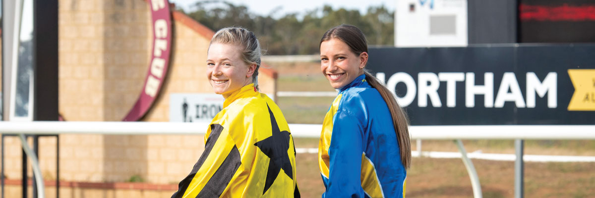 Two Female jockeys on the track